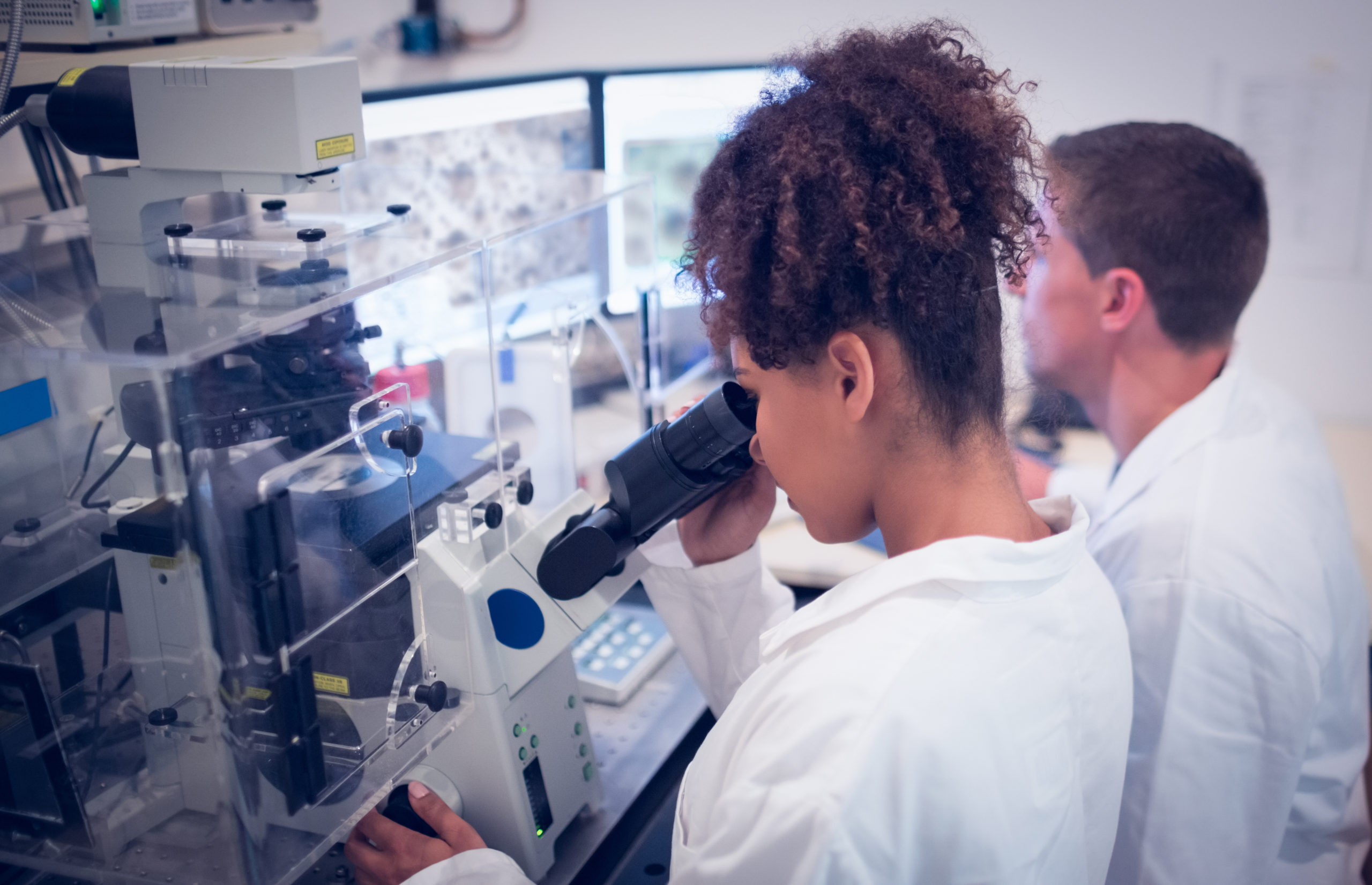 internal medicine doctor looking at microscope