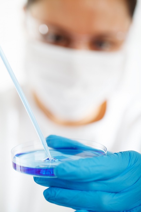 medical worker wearing gloves doing research