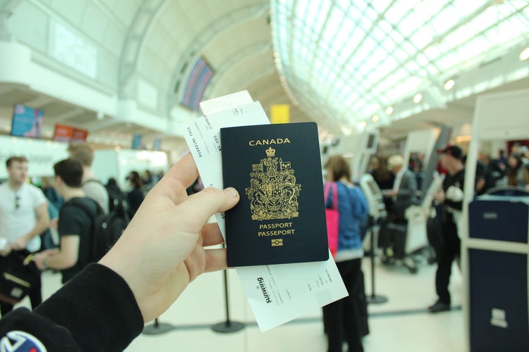 hand holding Canadian passport