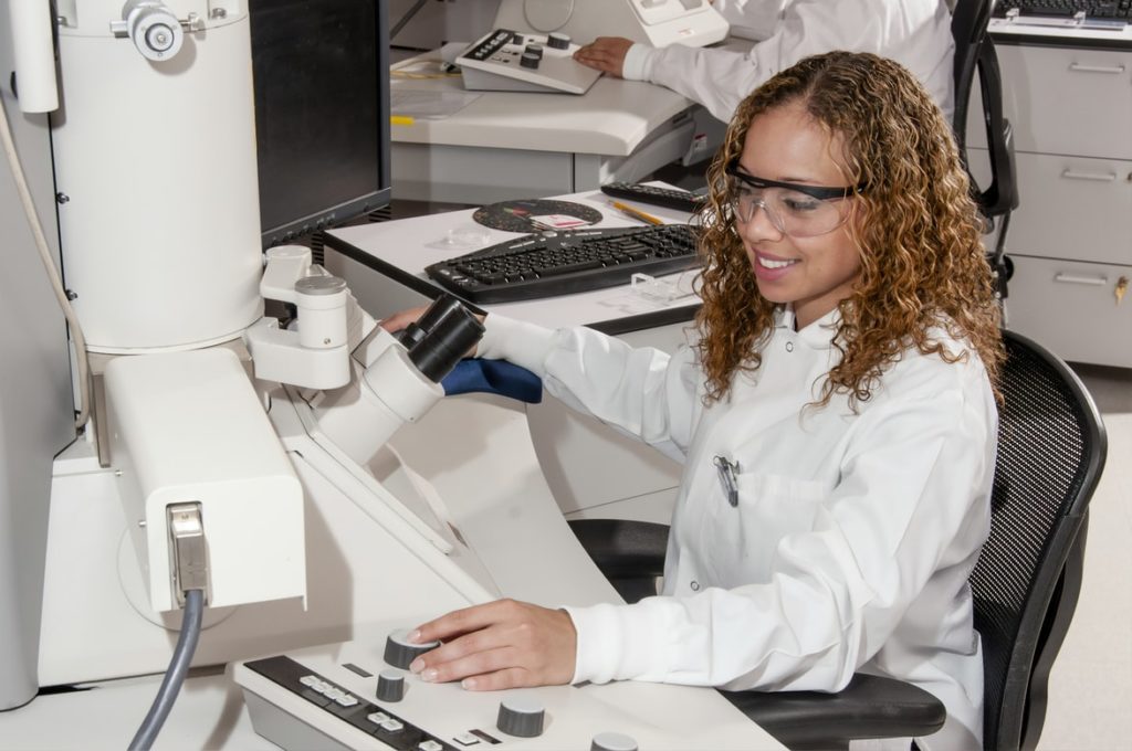 medical scientist using an electron microscope
