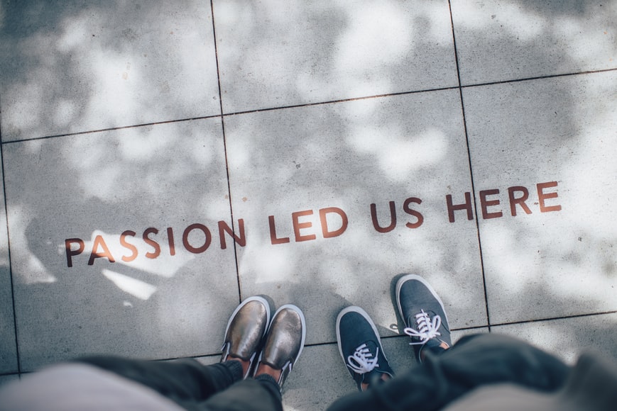 two people standing over the words passion led us here
