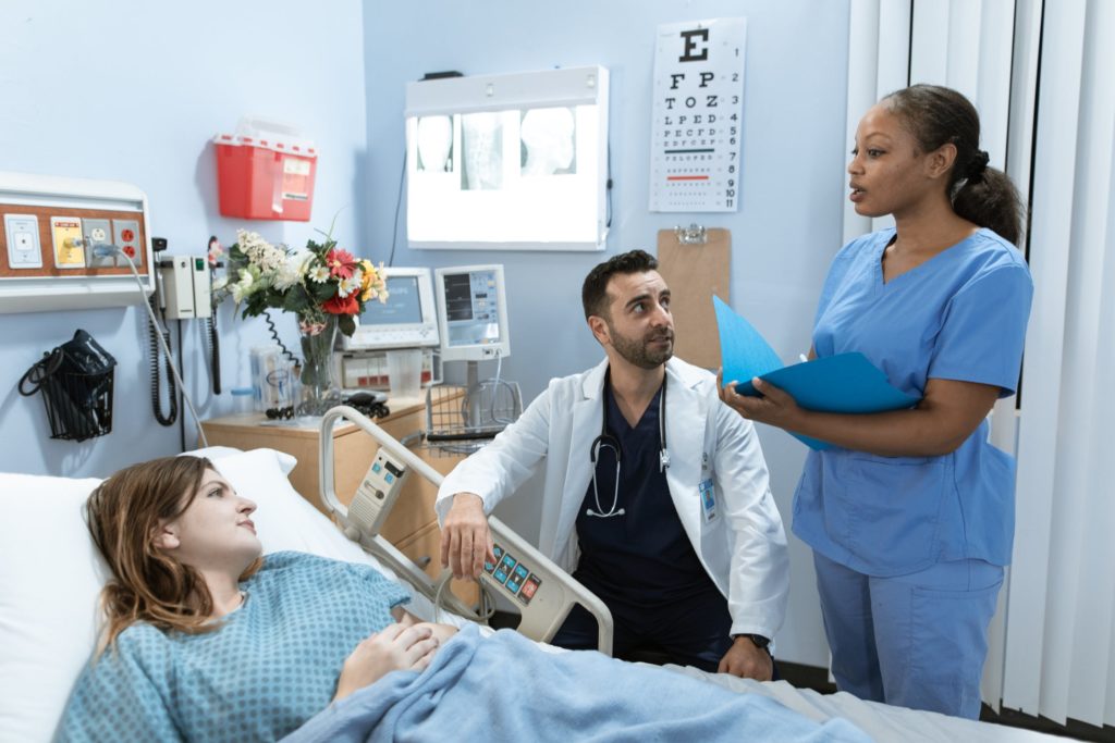 nurse and doctor speaking with patient