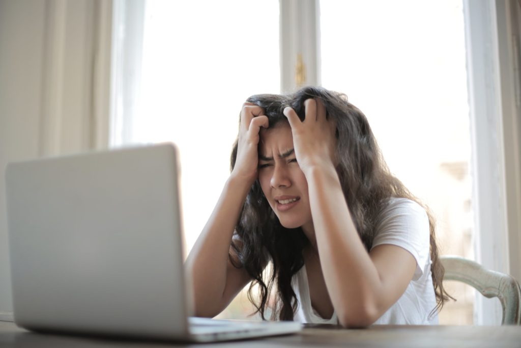 stressed woman looking at laptop