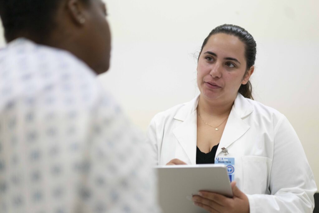 resident doctor speaking to patient